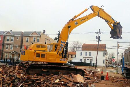 Demolition Crane loading waste into a Truck.